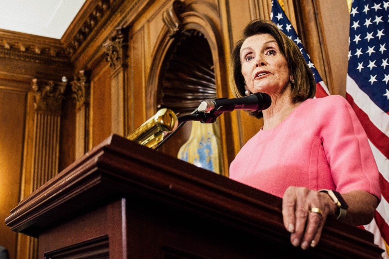 Pelosi speaking at a podium.